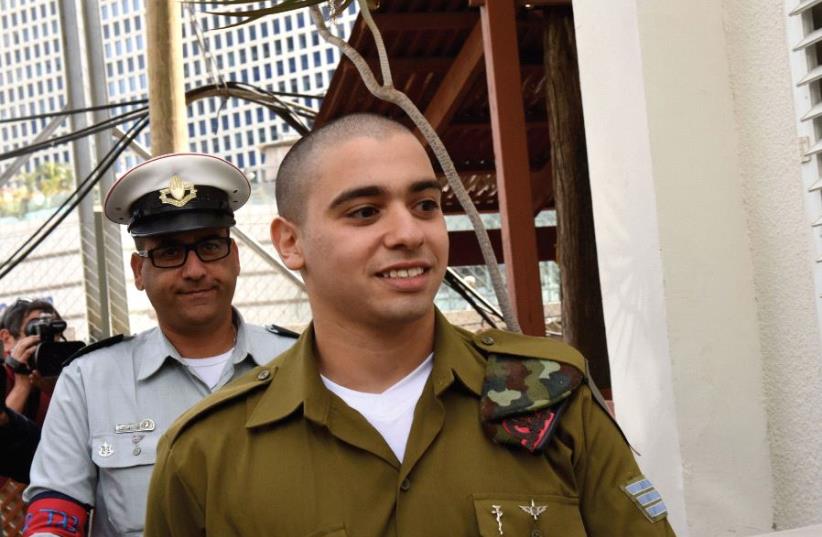 Sgt. Elor Azaria arrives at a military court in Tel Aviv on January 24 for the beginning of hearings on his sentencing for manslaughter. (photo credit: REUTERS)