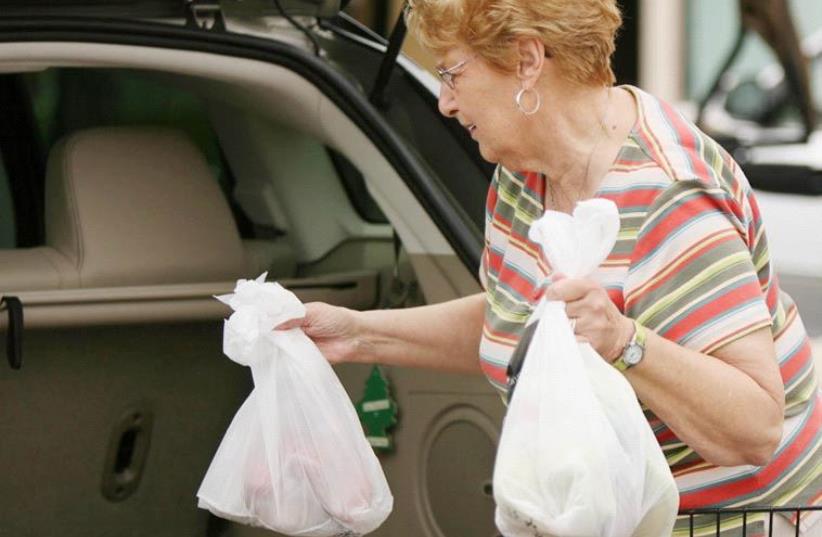 Paying for plastic bags (photo credit: TNS)