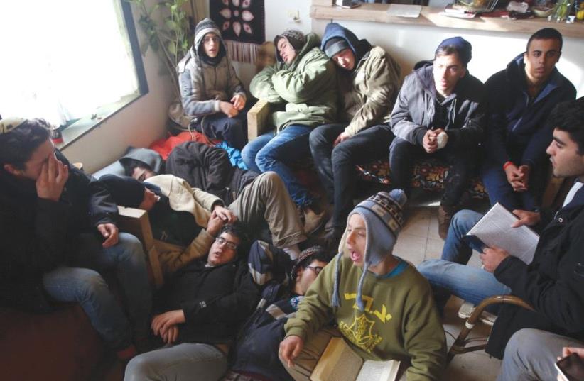 YOUNG PROTESTERS sit in a caravan singing and resting as they wait to be evacuated by police officers from the illegal outpost in Amona. (photo credit: MARC ISRAEL SELLEM/THE JERUSALEM POST)