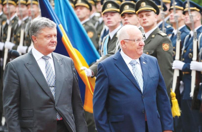 PRESIDENT REUVEN RIVLIN walks with his Ukrainian counterpart, Petro Poroshenko, during a welcoming ceremony in Kiev last September. (photo credit: REUTERS)