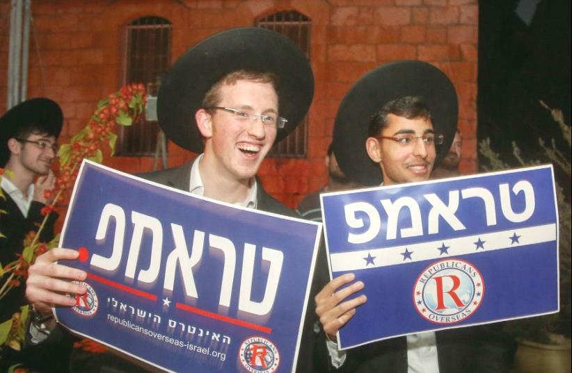 Ultra-Orthodox men with Trump signs in Hebrew (photo credit: MARC ISRAEL SELLEM)