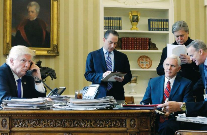 President Donald Trump, joined by (left to right) Chief of Staff Reince Priebus, Vice President Mike Pence, senior adviser Steve Bannon, Communications Director Sean Spicer and National Security Advisor Michael Flynn (photo credit: REUTERS)