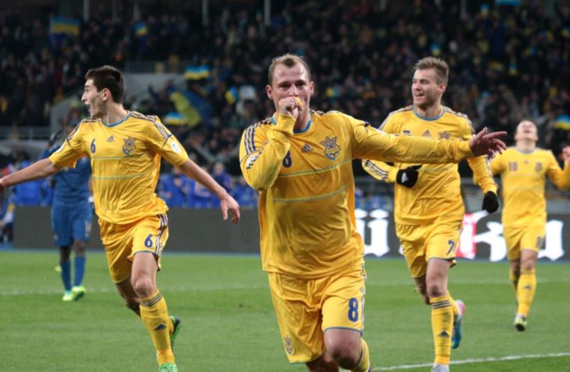 Ukraine's Roman Zozulya (front) celebrates his goal with team mates during their 2014 World Cup [File] (photo credit: REUTERS)