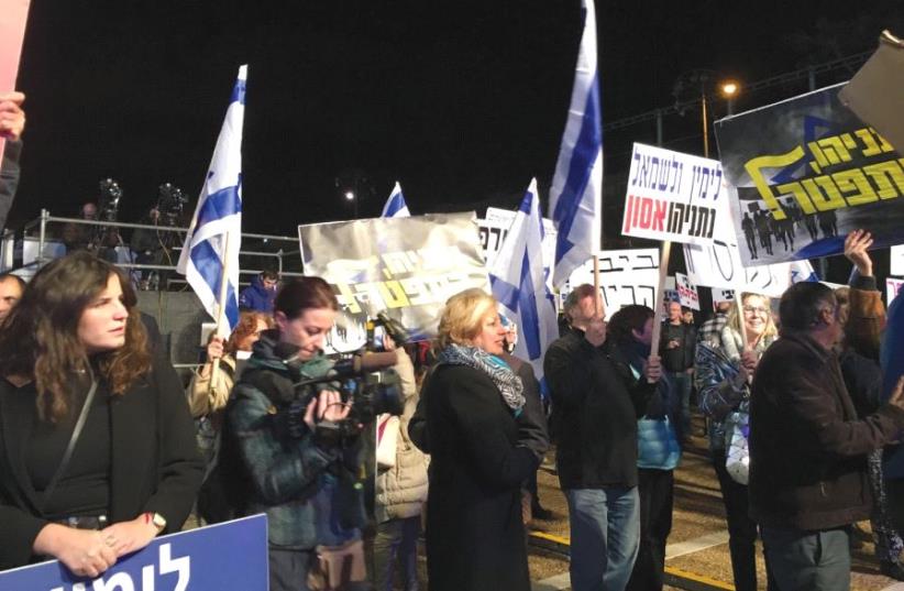 PROTESTERS RALLY against Prime Minister Benjamin Netanyahu at Rabin Square in Tel Aviv last night. (photo credit: LIDAR GRAVÉ-LAZI)