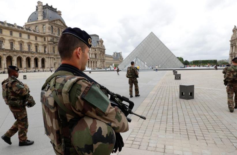 French army soldiers patrol near the Louvre Museum Pyramid's main entrance in Paris, France (photo credit: REUTERS)
