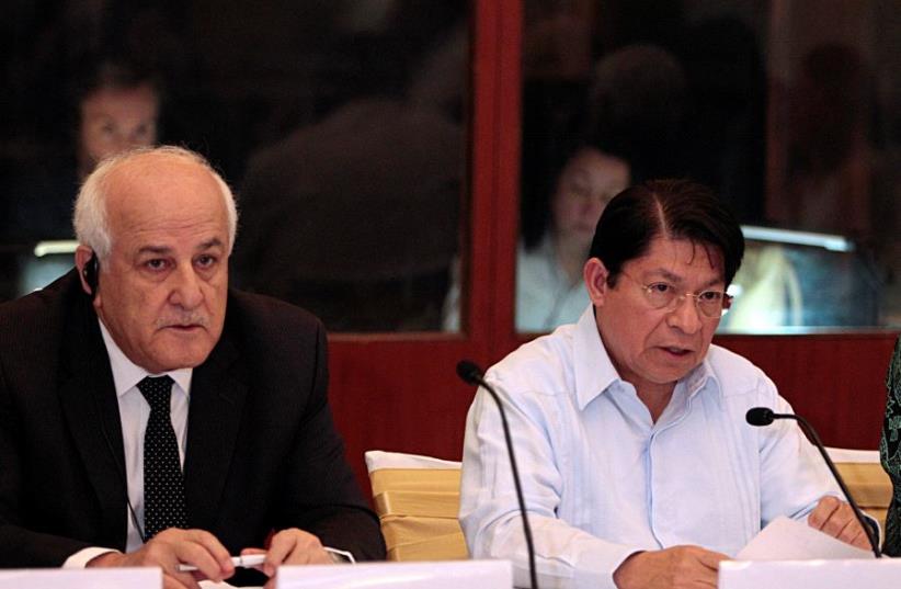Nicaragua's Foreign Minister Denis Moncada (R) speaks while flanked by the Permanent Observer of Palestine to the United Nations (UN), Riyad Mansour during a meeting with members of the Committee for the Exercise of the Inalienable Rights of the Palestinian People in Managua, Nicaragua February 4, 2 (photo credit: REUTERS)