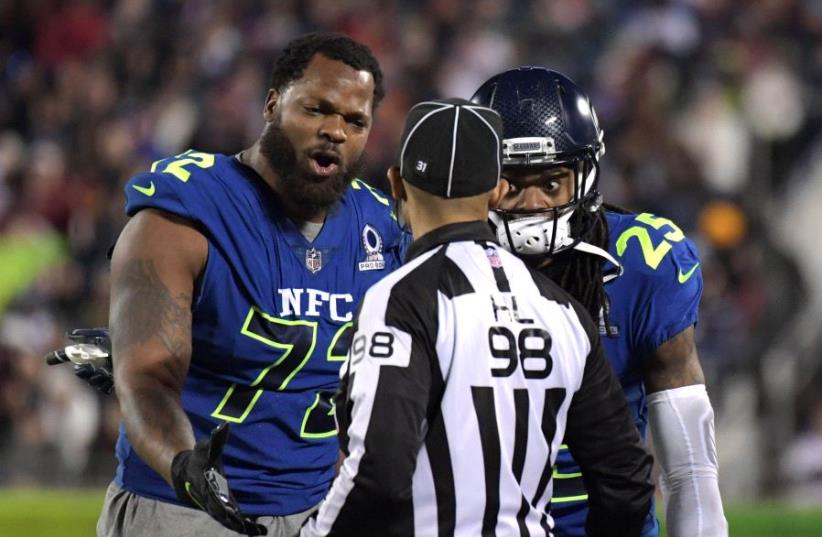 NFC defensive end Michael Bennett (72) and cornerback Richard Sherman (25) of the Seattle Seahawks  (photo credit: REUTERS)