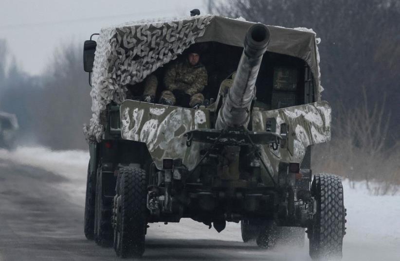 A UKRAINIAN military vehicle rushes to the front as fighting flares in Ukraine between separatists and the government. (photo credit: REUTERS)