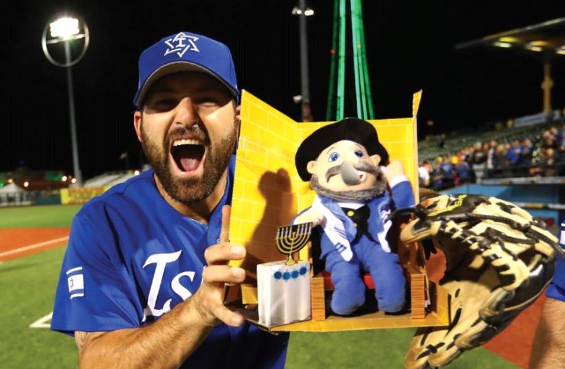 The merry prankster Cody Decker celebrates winning the Brooklyn qualifier with his Mensch on the Bench team mascot (photo credit: ALEX TRAUTWIG / MLB PHOTOS VIA GETTY IMAGES)
