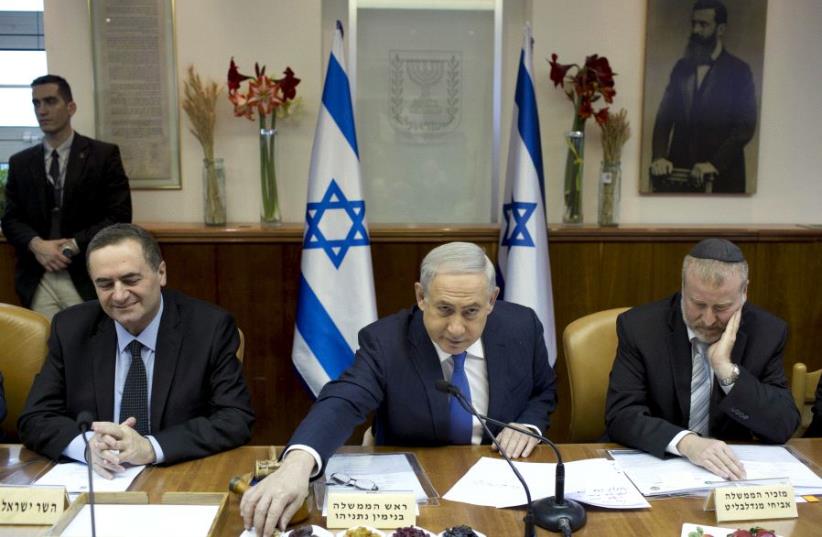 Prime Minister Benjamin Netanyahu (C) eats fruits and nuts  (photo credit: REUTERS)