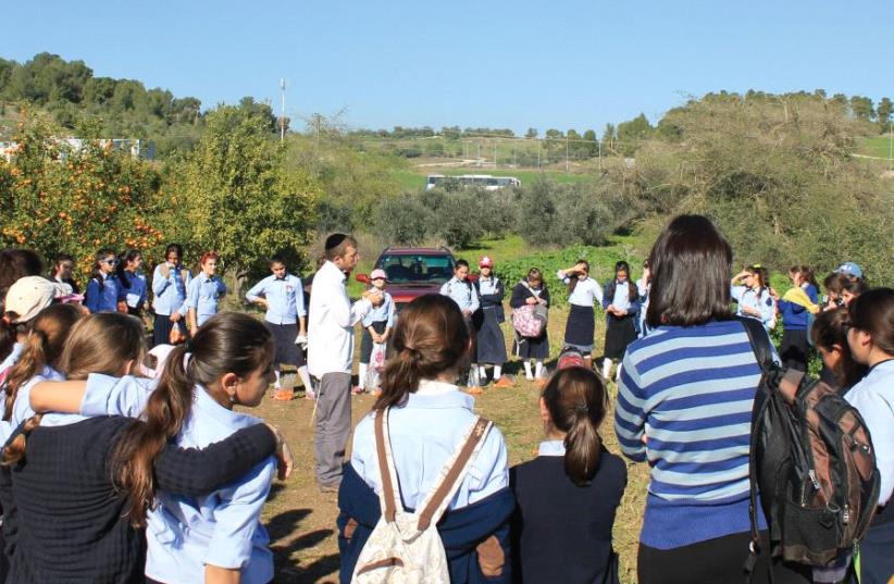 Leshomra CEO Avishai Himelfarb leads an educational farm tour for Beis Yaakov high-school girls (photo credit: LESHOMRA)