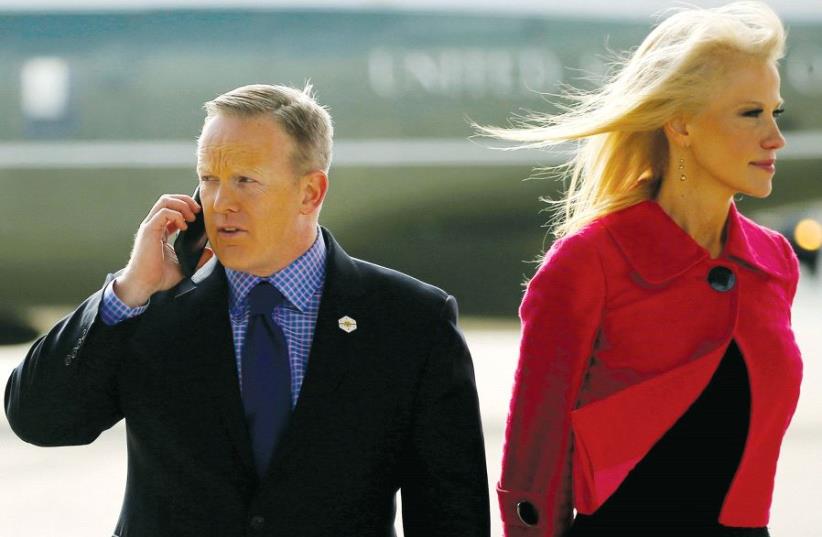 White House spokesman Sean Spicer and senior adviser Kellyanne Conway – who has recently defended what she referred to as ‘alternative facts’ – wait for US President Donald Trump to arrive to board Air Force One for travel to Philadelphia from Joint Base Andrews, Maryland, last month (photo credit: REUTERS)