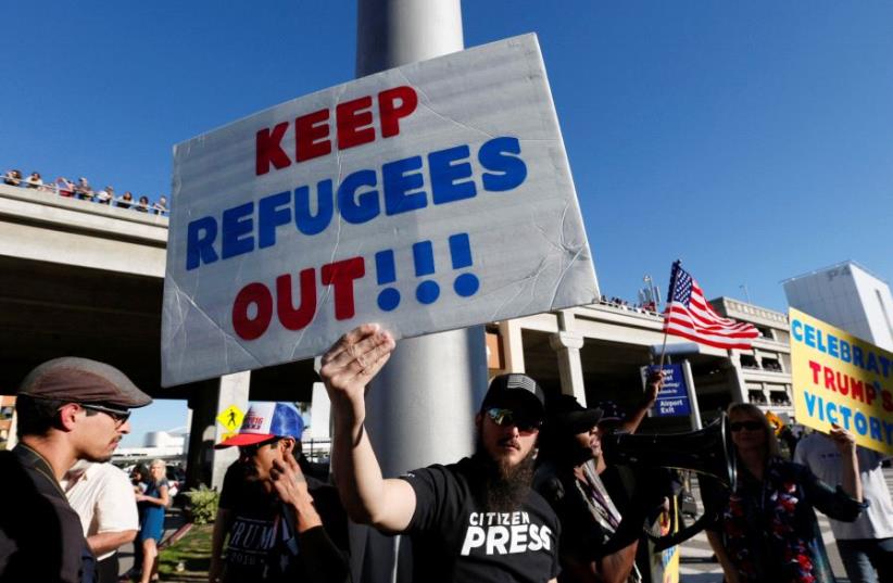 Pro-Trump demonstrators protest in support of the travel ban imposed by US President Donald Trump's executive order at Los Angeles International Airport in Los Angeles, California (photo credit: REUTERS)