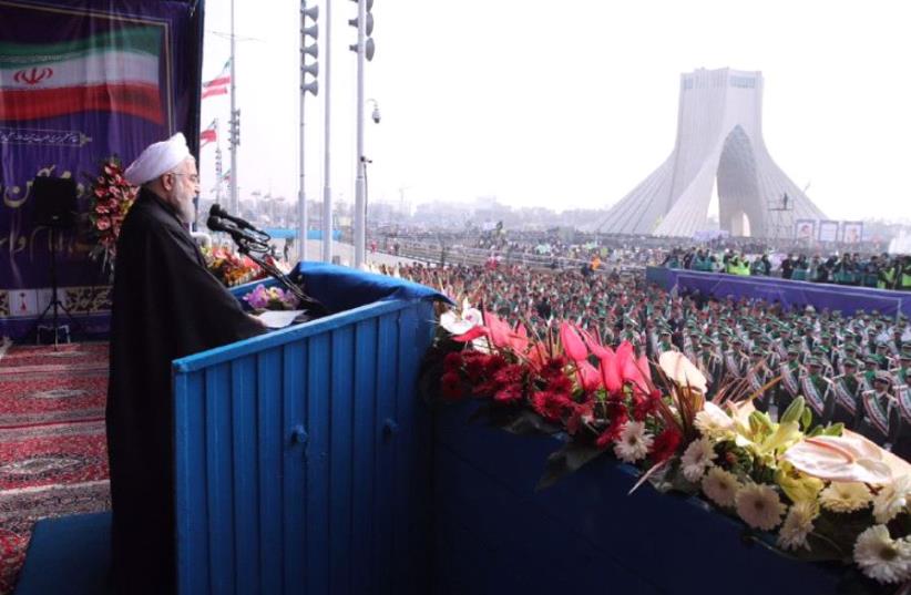 Iranian President Hassan Rouhani delivering a speech at Azadi Square in the capital of Iran ,  Tehran ,  during a ceremony to mark the 38th anniversary of the Islamic revolution. (photo credit: HO / IRANIAN PRESIDENCY / AFP)