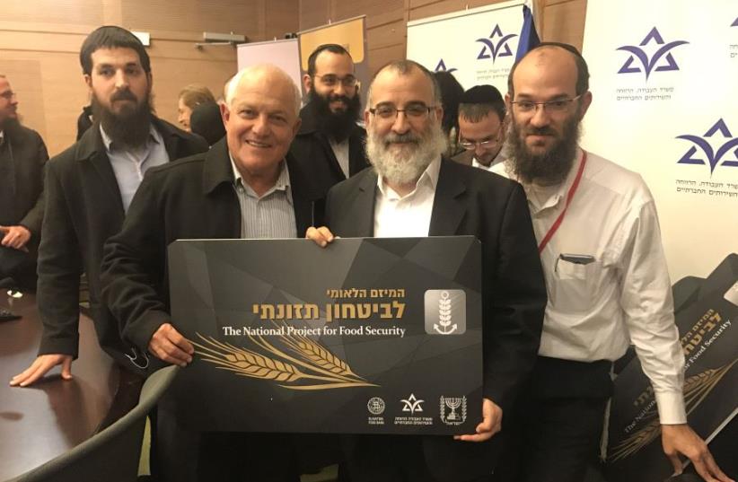 Labor and Social Services Minister Haim Katz along with Mendy Blau, Israel director of Colel Chabad at the launch of the food security initiative in the Knesset (photo credit: LABOR AND SOCIAL SERVICES MINISTRY)