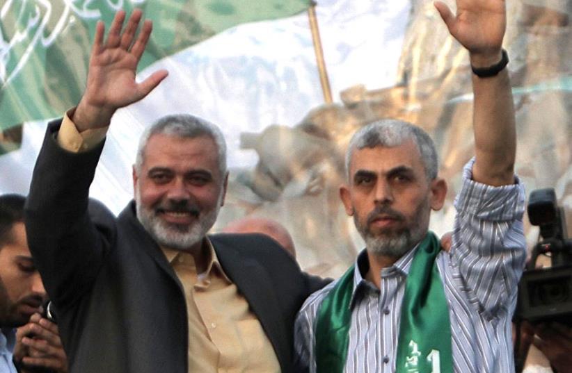 Ismail Haniyeh (L) and Yahya Sinwar (R) (photo credit: SAID KHATIB / AFP)