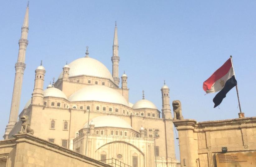 AN EGYPTIAN flag flutters in front of the Muhammad Ali mosque in Cairo. (photo credit: SETH J. FRANTZMAN)
