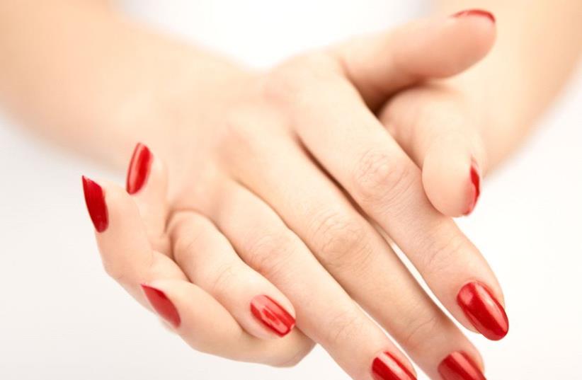 Hands with the red manicure (illustrative) (photo credit: INGIMAGE)