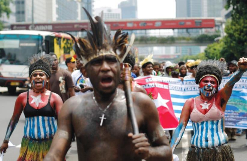 WEST PAPUANS shout slogans during a rally to commemorate the 50th anniversary of West Papuan independence from Dutch rule, in Jakarta, Indonesia, in December 2011. ( (photo credit: REUTERS)