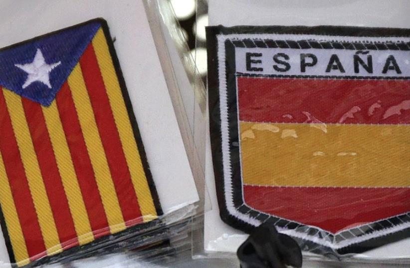 THE COLORS of the Spanish flag are seen next to a Catalan flag in Barcelona. (photo credit: REUTERS)