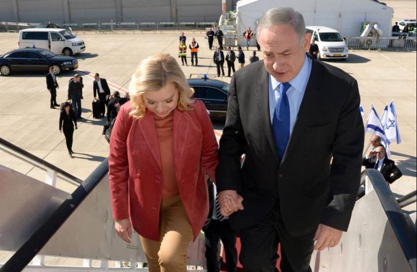 Prime Minister Benjamin Netanyahu and his wife Sara on their way to Singapore (photo credit: CHAIM ZACH / GPO)