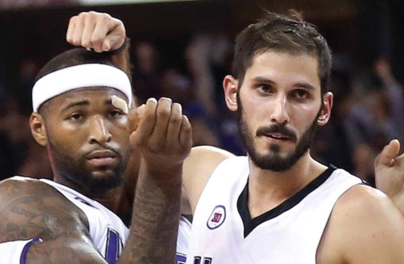 ISRAELI FORWARD Omri Casspi (right) was packaged with his All-Star teammate from the Sacramento Kings, DeMarcus Cousins (left), in a trade to the New Orleans Pelicans yesterday. The Pelicans will mark the fourth NBA club (with two Sacramento stops) for the 28-year-old Casspi in his eight years in th (photo credit: REUTERS)