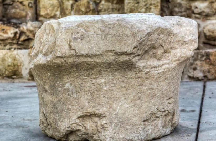 The 1,800-year-old inscribed stone. (photo credit: COURTESY OF BEIT ZINATI)