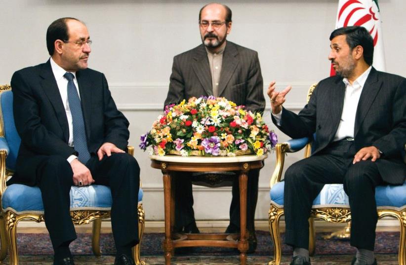 FORMER IRANIAN president Mahmoud Ahmadinejad (right) speaks with Iraqi Prime Minister Nuri al-Maliki (left) during a 2010 meeting in Tehran (photo credit: REUTERS)