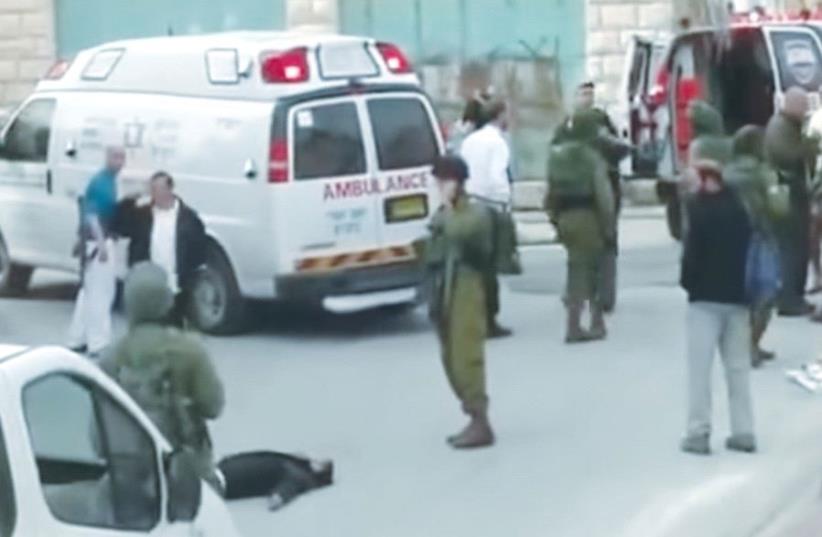 A STILL PHOTO from the famous video shows Sgt. Elor Azaria shooting an incapacitated terrorist in Hebron on March 24, 2016. (photo credit: B'TSELEM)