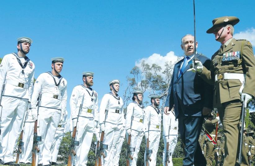 PRIME MINISTER Benjamin Netanyahu reviews an Australian Military Forces honor guard at Admiralty House in Sydney yesterday. (photo credit: REUTERS)