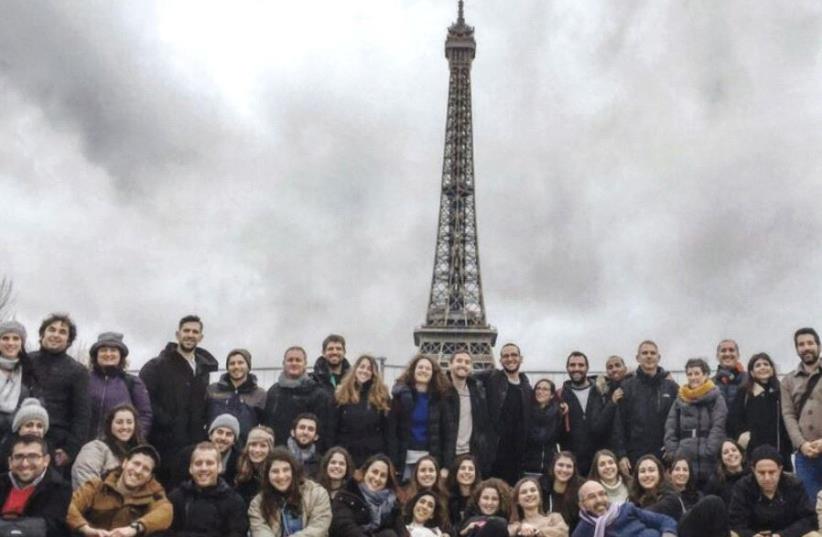 FRANCE’S JEWISH AGENCY employees and participants pose in front of the Eiffel Tower. (photo credit: JAFI)