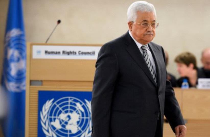 Palestinian President Mahmud Abbas arrives to delivers a speech during the United Nations Human Rights Council on February 27, 2017 in Geneva (photo credit: FABRICE COFFRINI / AFP)