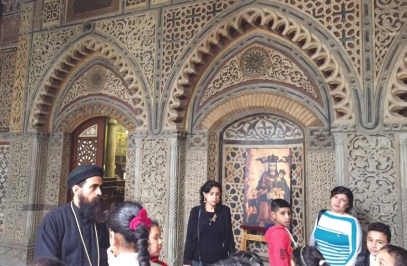 Coptic Christians crowd into a church in Cairo. Copts in the Sinai have recently come under attack by Islamic State (photo credit: SETH J. FRANTZMAN)