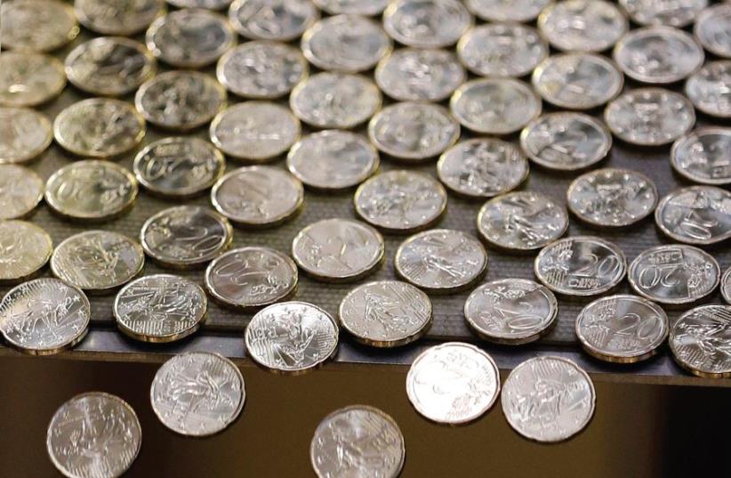 WHAT WILL become of these? Euros fall off a table after being minted. The EU also may be teetering on the brink. (photo credit: REUTERS)