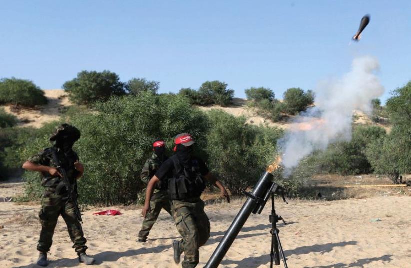 PALESTINIANS FIRE a mortar shell in the southern Gaza Strip in 2015 (photo credit: REUTERS)