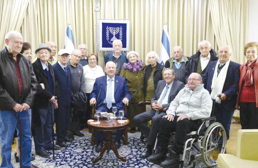 PRESIDENT REUVEN RIVLIN sits in the center of former Lehi members and others marking 75 years since the death of the group’s founder Avraham Stern (photo credit: MARK NEYMAN/GPO)