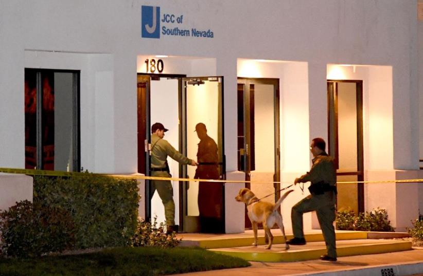  Las Vegas Metropolitan Police Department K-9 officers search the Jewish Community Center of Southern Nevada after an employee received a suspicious phone call that led about 10 people to evacuate the building on February 27, 2017 in Las Vegas, Nevada.  (photo credit: ETHAN MILLER / GETTY IMAGES NORTH AMERICA / AFP)