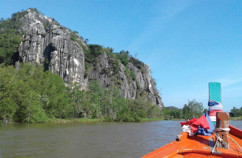 THE PROW of our boat points down between the mountains on both sides of the Pretchaburi River (photo credit: ARI BAR-OZ)