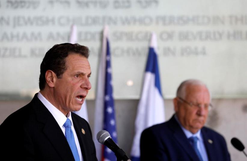 Andrew Cuomo (L), Governor of New York, stands next to Israeli President Reuven Rivlin as he speaks to members of the media following a ceremony in the Hall of Remembrance at Yad Vashem Holocaust Memorial in Jerusalem, March 5, 2017 (photo credit: REUTERS)