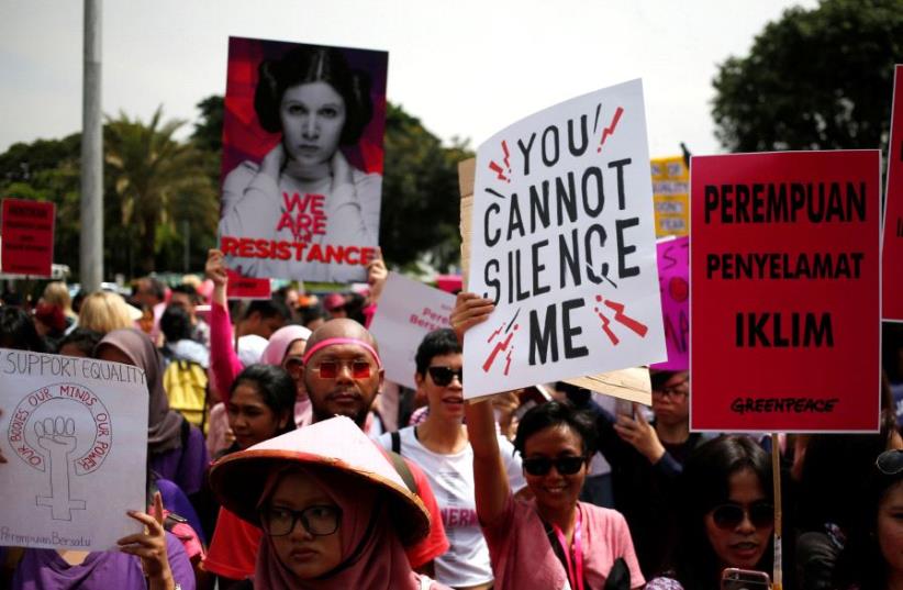 People take part in a rally calling for women's rights and equality ahead of International Women's Day in Jakarta, Indonesia, March 4, 2017 (photo credit: REUTERS)