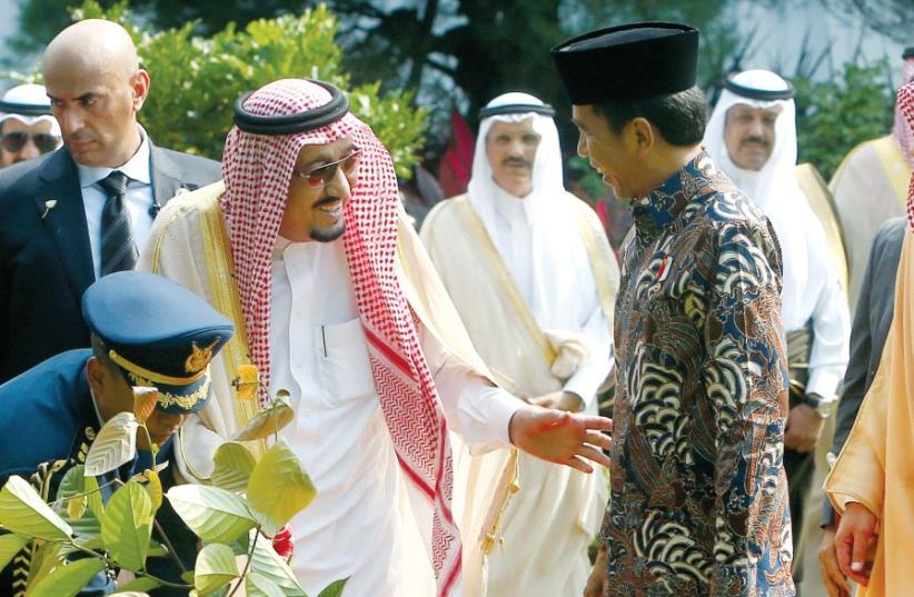 Indonesian President Joko Widodo (center-right) talks to Saudi Arabia's King Salman Abdulaziz Al-Saud (center-left) after planting a tree at the Presidential Palace in Jakarta last week, during a historic visit to Indonesia, the first visit by a Saudi head of state in 47 years (photo credit: REUTERS)