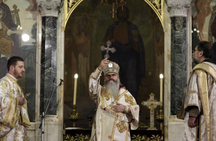 Metropolitan Kirill (C), deputy chairman of the Bulgarian Orthodox Church, blesses during a Christmas Eve mass in Alexander Nevski Cathedral in Sofia (photo credit: REUTERS)