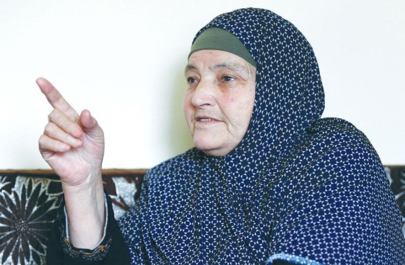 KAMLEH DAQAMSEH, mother of the Jordanian soldier convicted of killing seven Israeli schoolgirls in March 1997, speaks to the media at her home in the village of Ibdir yesterday after her son’s release (photo credit: REUTERS)