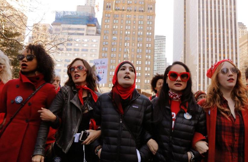 Organizers Linda Sarsour (C), Carmen Perez (2nd R) and Bob Bland (R) lead during a 'Day Without a Woman' march on International Women's Day in New York, US, March 8, 2017 (photo credit: REUTERS)