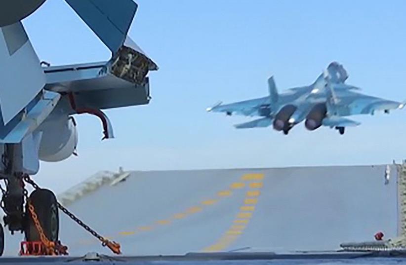 An image grab taken from a video footage made available on the Russian Defence Ministry's official website on November 15, 2016, reportedly shows a jet taking off from the Admiral Kuznetsov aircraft carrier in the eastern Mediterranean off the Syrian coast during a strike against Islamic State (IS)  (photo credit: HO / RUSSIAN DEFENCE MINISTRY / AFP)