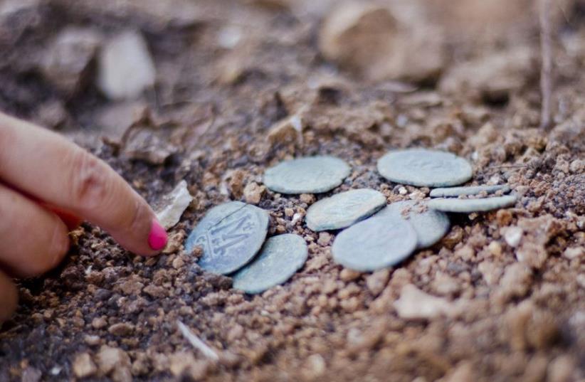 Rare 1,400-year-old bronze Byzantine-era coins found near Jerusalem’s Highway 1 (photo credit: YOLI SCHWARTZ/IAA)