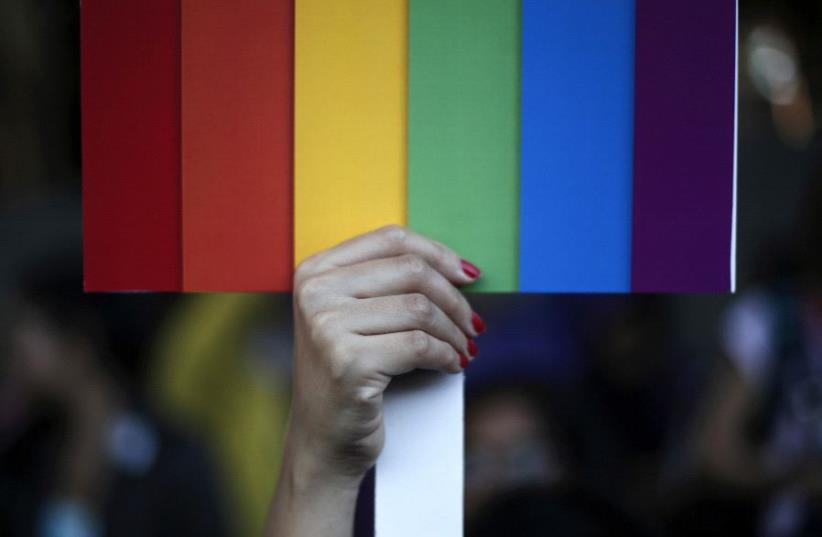 A rainbow coloured placard in the colors of the LGBT flag [Illustrative] (photo credit: REUTERS)