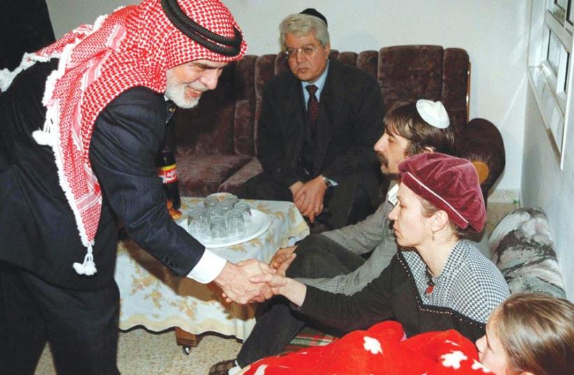 JORDAN’S KING Hussein leans over and shakes hands with Margalit Badayev, the mother of slain Israeli schoolgirl Shiri, during his 1997 condolence call at the mourning parent’s home.  (photo credit: REUTERS)