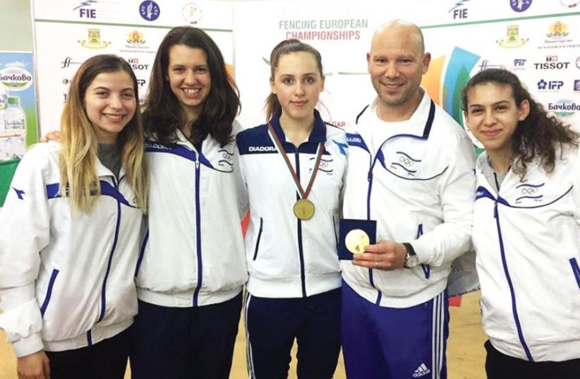 Israeli fenc er Vera Kanevski (center) poses with fellow delegation members (from left) Nikol Gavrielko, Yana Botvinik, coach Doron Levit and Dar Hecht after winning the gold medal at the European Junior Championships earlier this month in Plovdiv, Bulgaria. Due to the financial situation of the Isr (photo credit: AUGUSTO BIZZI)