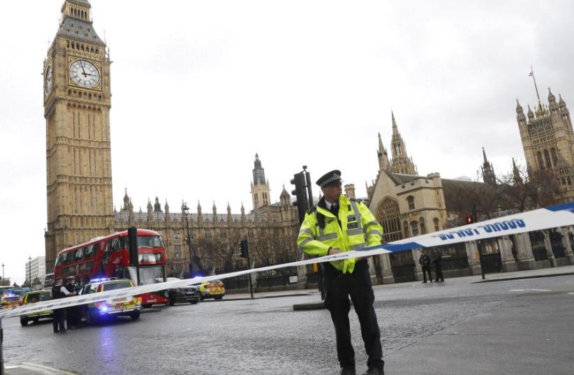 Police tapes off Parliament Square after reports of loud bangs, in London, Britain, March 22, 2017.  (photo credit: REUTERS)